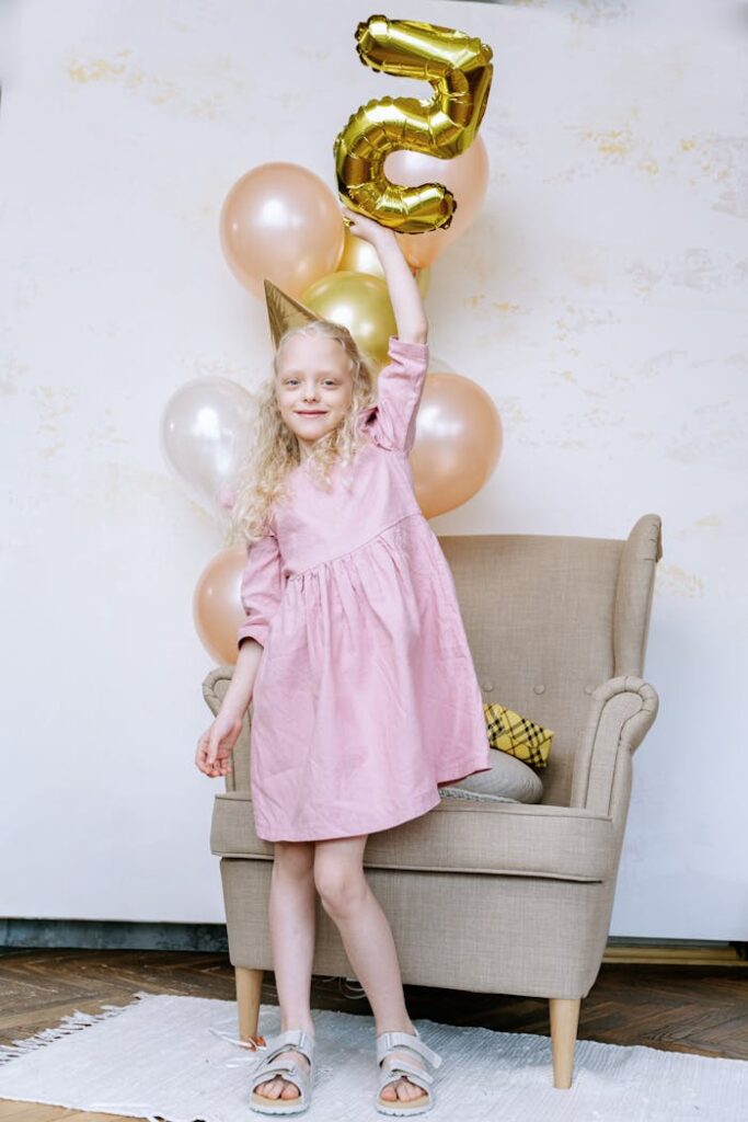 Girl in Pink Dress Holding Balloons